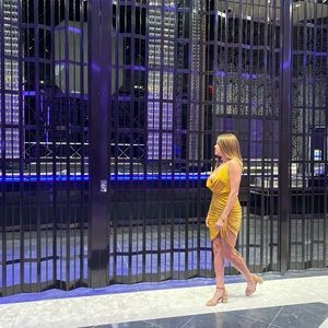 Gold/mustard backless dress with a cleavage,